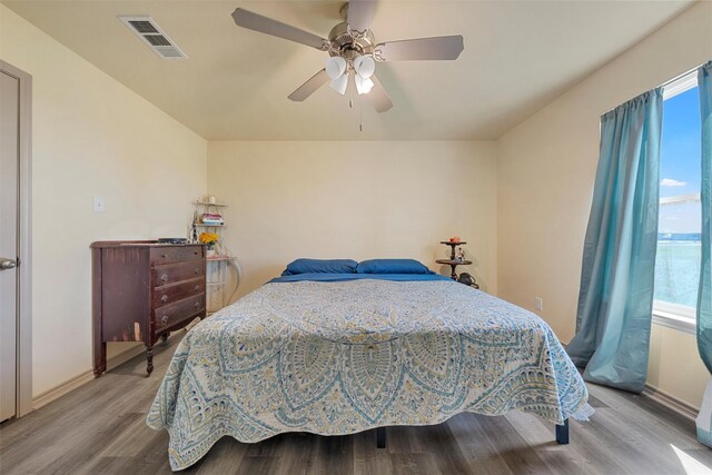 736 County Road 478, Lott, TX 76656 - bedroom with baseboards, a ceiling fan, wood finished floors, and visible vents