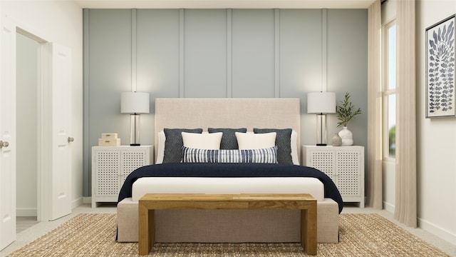 bedroom with light colored carpet, a decorative wall, and baseboards