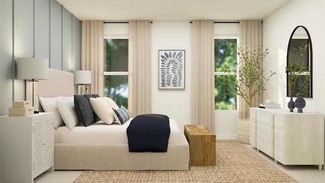 bedroom featuring multiple windows and light colored carpet