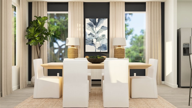 dining area with baseboards and wood finished floors