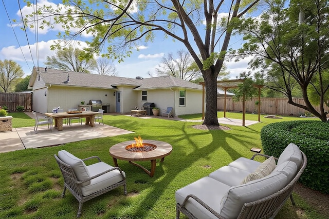 back of property with a patio, fence, a yard, and an outdoor living space with a fire pit