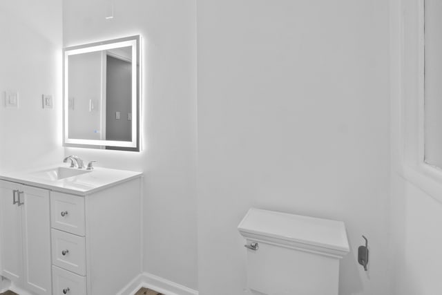 bathroom with toilet and vanity