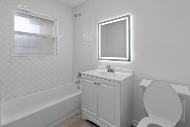 full bathroom with toilet, shower / bathtub combination, wood finished floors, and vanity