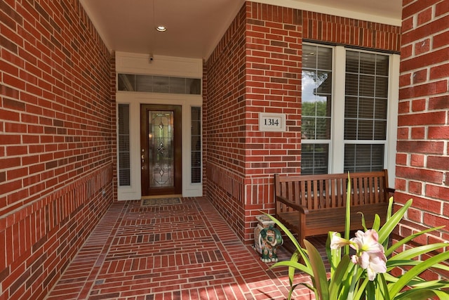 doorway to property with brick siding