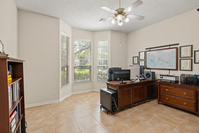 office area with light tile patterned floors, baseboards, ceiling fan, and visible vents
