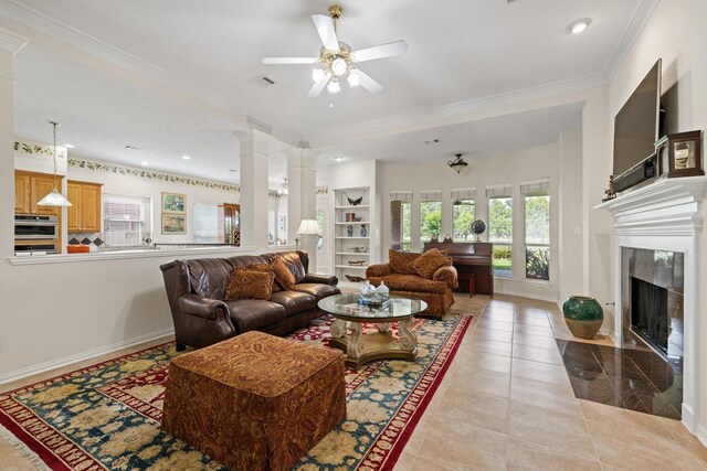 living area featuring a fireplace, a ceiling fan, baseboards, light tile patterned floors, and visible vents
