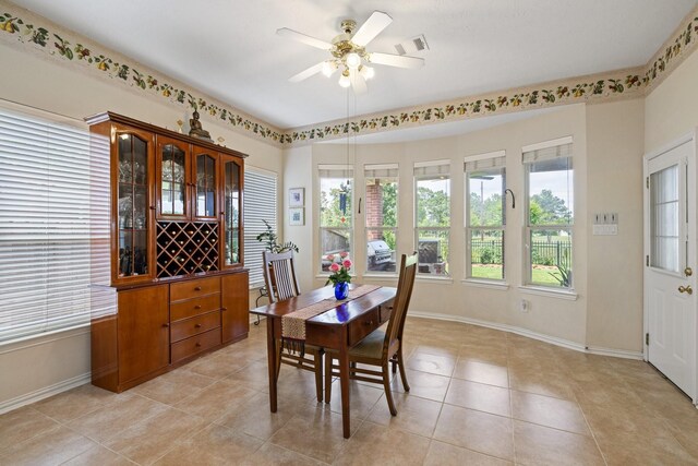 dining area featuring light tile patterned flooring, baseboards, visible vents, and ceiling fan