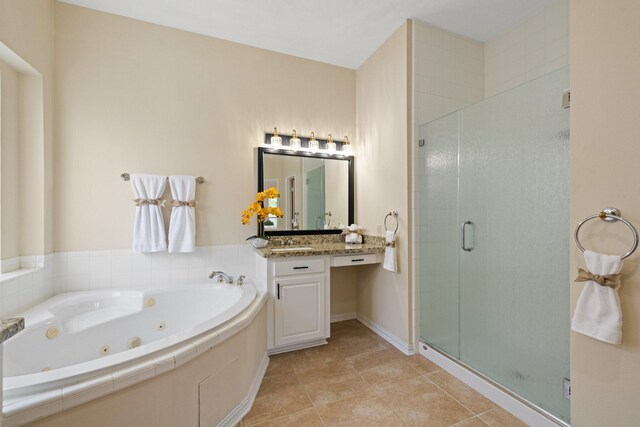 bathroom featuring a jetted tub, vanity, tile patterned flooring, and a shower stall