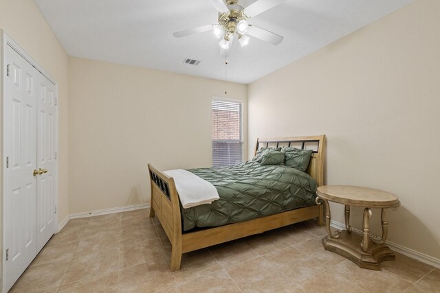 bedroom featuring visible vents, a ceiling fan, baseboards, and light tile patterned flooring