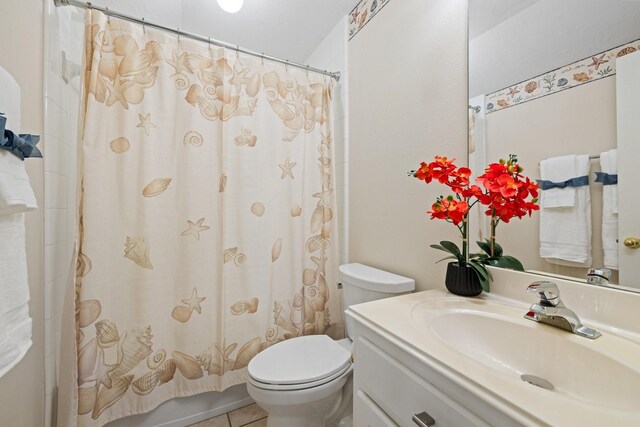 bathroom featuring toilet, tile patterned flooring, and vanity