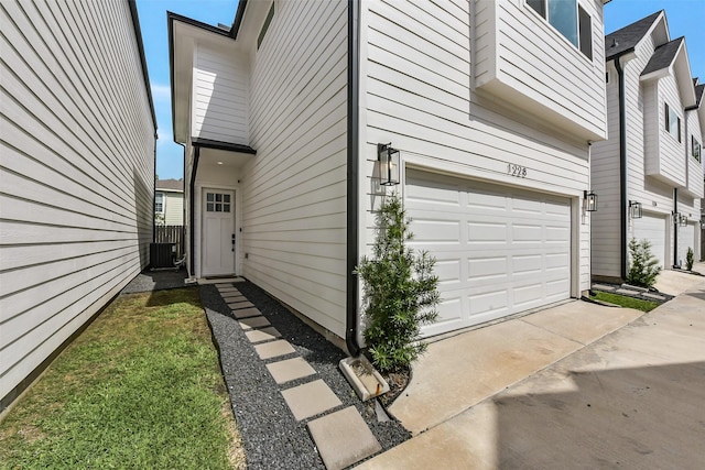 exterior space with a garage and cooling unit