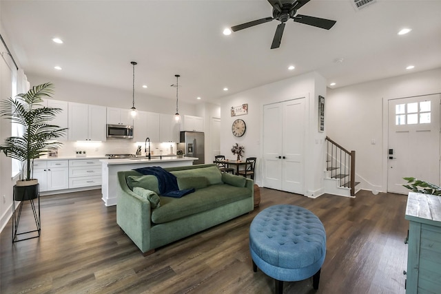 living room featuring stairway, a ceiling fan, recessed lighting, and dark wood-type flooring