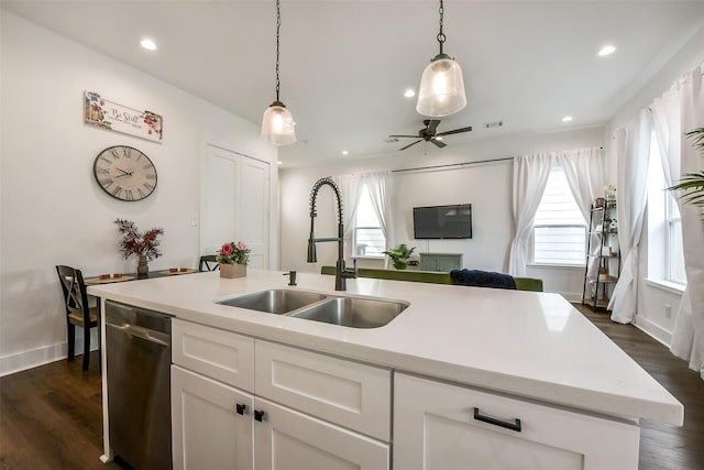 1228 Mcneil St, Houston, TX 77009 - kitchen with a sink, stainless steel dishwasher, white cabinetry, light countertops, and pendant lighting
