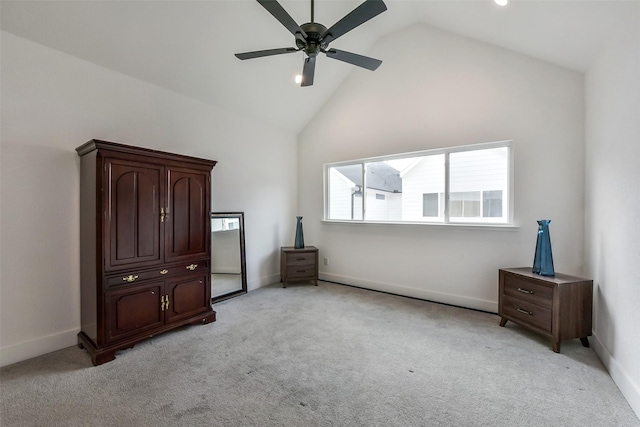 unfurnished bedroom with light colored carpet, baseboards, and high vaulted ceiling
