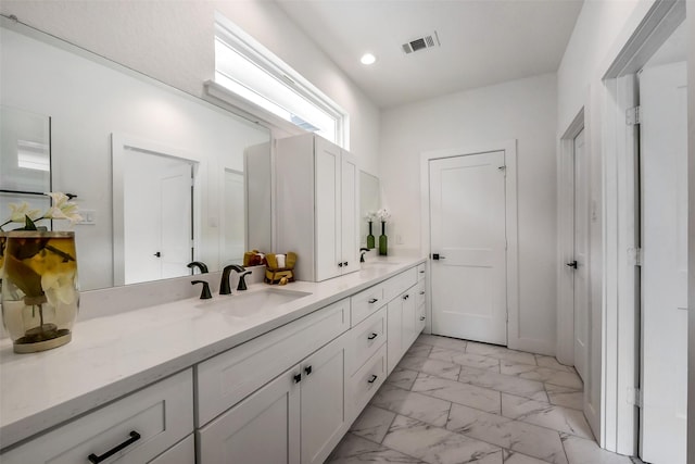 bathroom with recessed lighting, visible vents, marble finish floor, and vanity