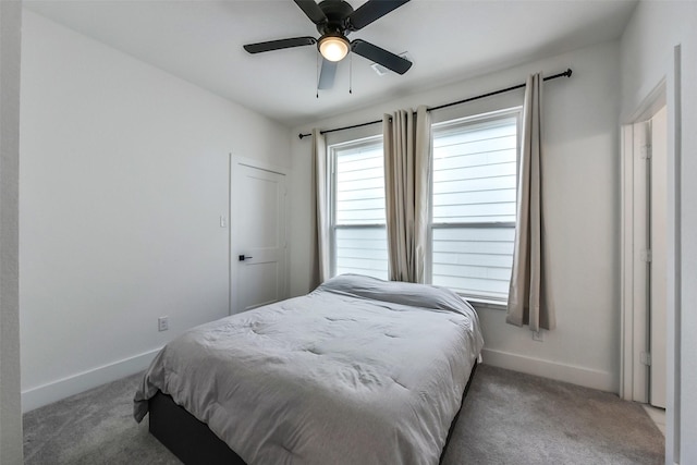 carpeted bedroom with baseboards and ceiling fan