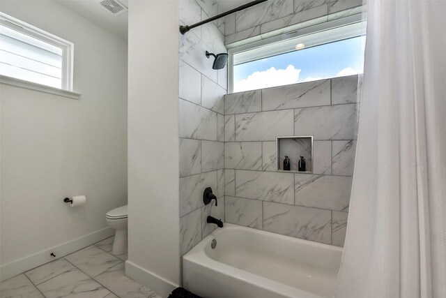 1228 Mcneil St, Houston, TX 77009 - full bathroom featuring baseboards, marble finish floors, toilet, and shower / bath combination with curtain