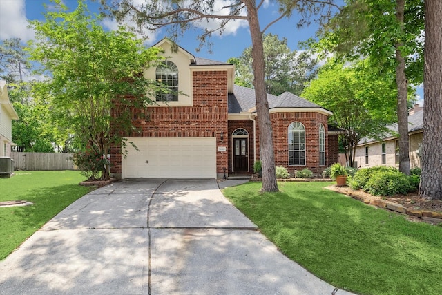 20611 Carmine Oak Ct, Humble, TX 77346 - traditional-style house with a front lawn, driveway, brick siding, an attached garage, and fence