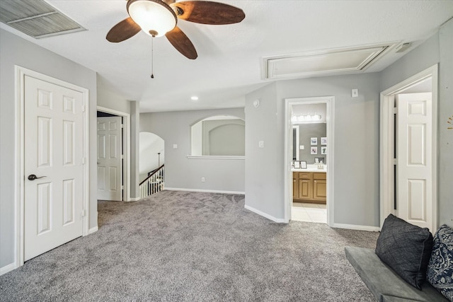 20611 Carmine Oak Ct, Humble, TX 77346 - unfurnished living room with attic access, a ceiling fan, visible vents, baseboards, and light colored carpet