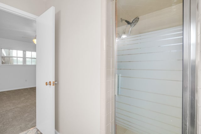 bathroom featuring baseboards and a stall shower