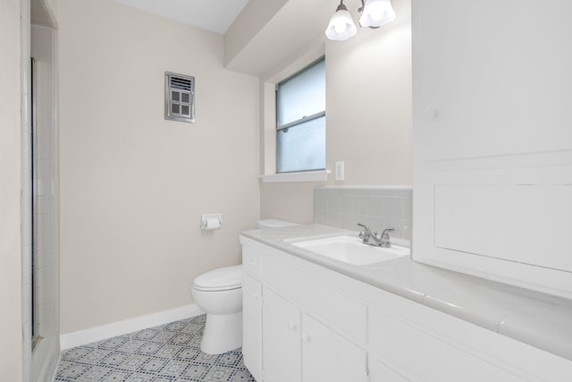 full bath with tasteful backsplash, an enclosed shower, toilet, vanity, and tile patterned flooring