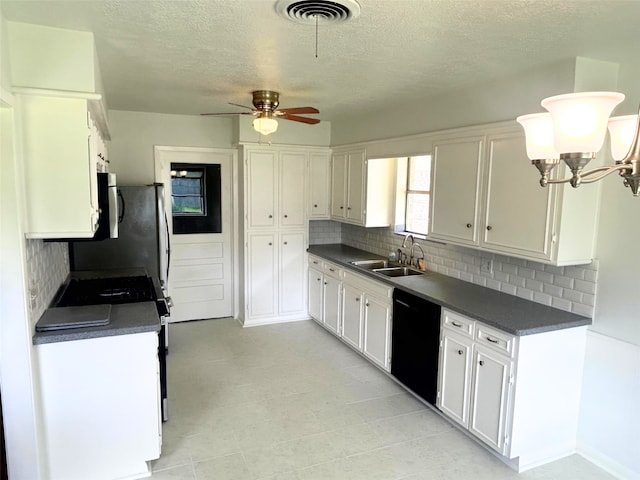 kitchen with white cabinetry, a sink, dark countertops, visible vents, and black dishwasher