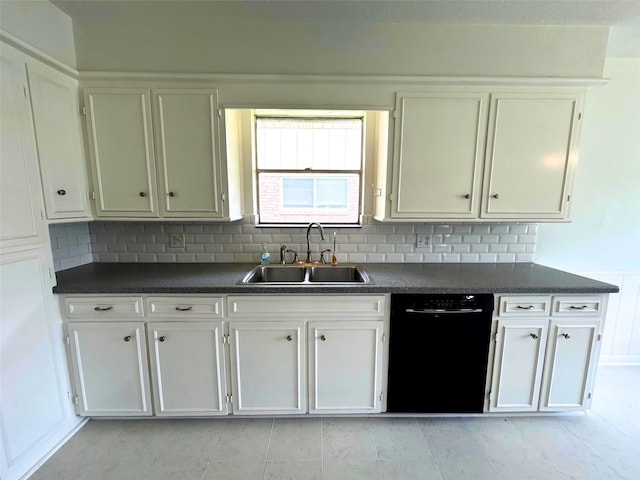 kitchen featuring black dishwasher, dark countertops, white cabinetry, and a sink