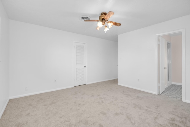 empty room featuring baseboards, visible vents, ceiling fan, and carpet flooring