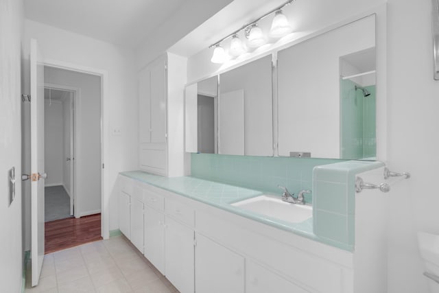 full bath with tasteful backsplash, a shower, baseboards, toilet, and vanity