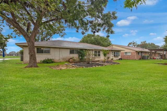 view of front of home with brick siding and a front lawn