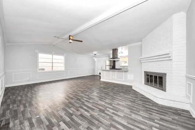 15030 Royal Shadows Dr, Houston, TX 77082 - unfurnished living room with a fireplace, a decorative wall, plenty of natural light, and dark wood-style floors