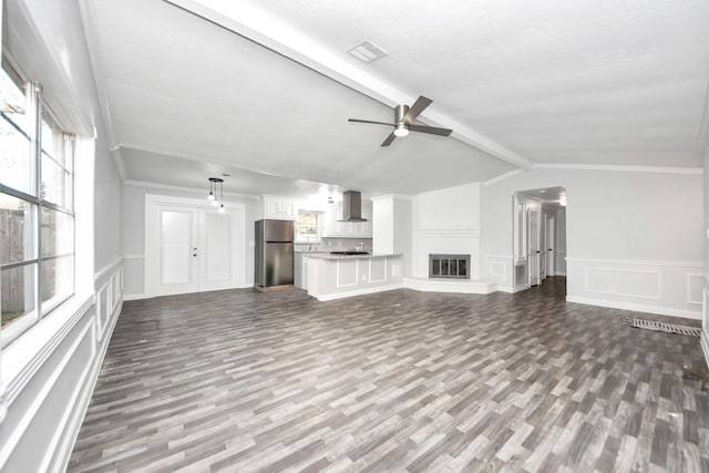 15030 Royal Shadows Dr, Houston, TX 77082 - unfurnished living room featuring a ceiling fan, visible vents, vaulted ceiling with beams, and dark wood finished floors