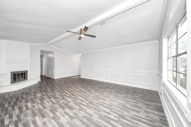 15030 Royal Shadows Dr, Houston, TX 77082 - unfurnished living room featuring beamed ceiling, ceiling fan, a decorative wall, a fireplace, and wood finished floors