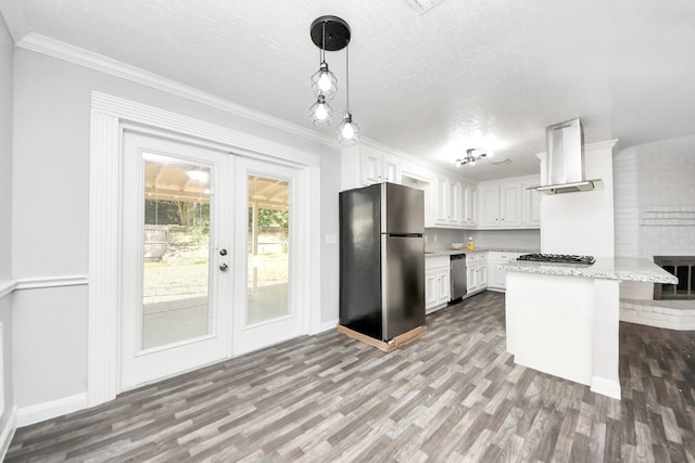 15030 Royal Shadows Dr, Houston, TX 77082 - kitchen featuring exhaust hood, french doors, white cabinets, appliances with stainless steel finishes, and wood finished floors