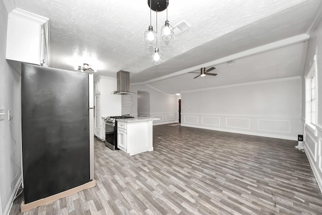 15030 Royal Shadows Dr, Houston, TX 77082 - kitchen with wood finished floors, a decorative wall, stainless steel appliances, white cabinets, and island exhaust hood
