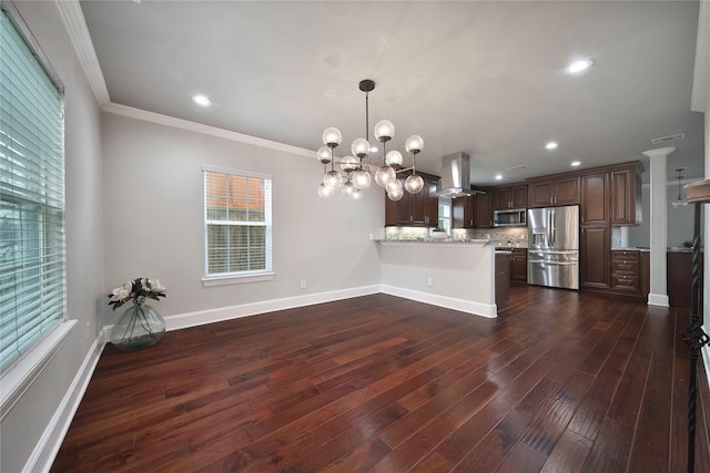 3327 Palm St, Houston, TX 77004 - kitchen with appliances with stainless steel finishes, island range hood, a peninsula, dark wood finished floors, and plenty of natural light