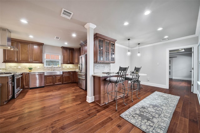 3327 Palm St, Houston, TX 77004 - kitchen with stainless steel appliances, wall chimney exhaust hood, glass insert cabinets, a sink, and backsplash