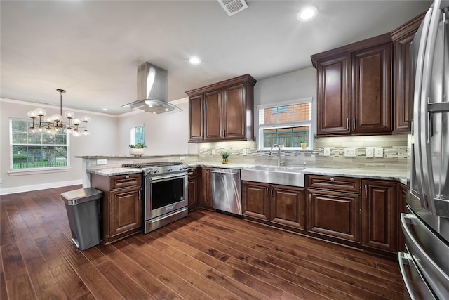 3327 Palm St, Houston, TX 77004 - kitchen with appliances with stainless steel finishes, island exhaust hood, a sink, a peninsula, and tasteful backsplash