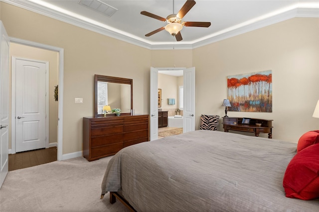 bedroom featuring a ceiling fan, visible vents, ornamental molding, carpet, and ensuite bath