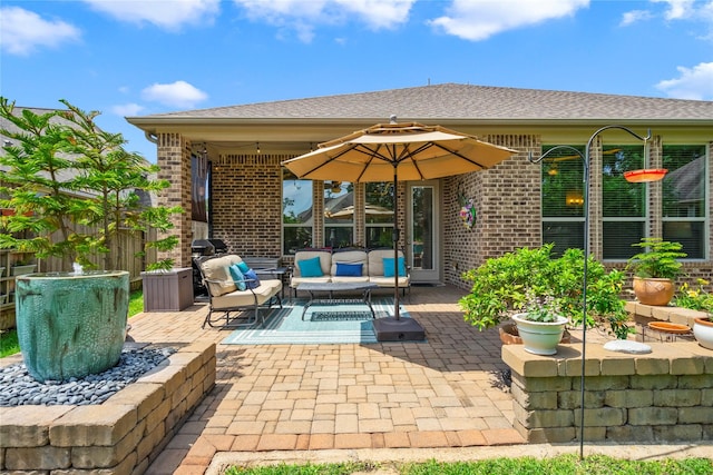 view of patio with fence and outdoor lounge area