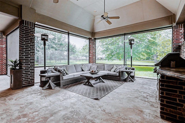 living area featuring a ceiling fan, concrete flooring, and high vaulted ceiling