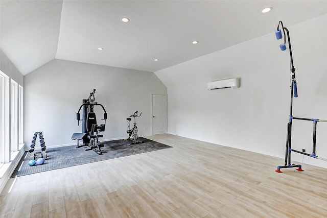workout area featuring wood finished floors, a wall unit AC, vaulted ceiling, and recessed lighting