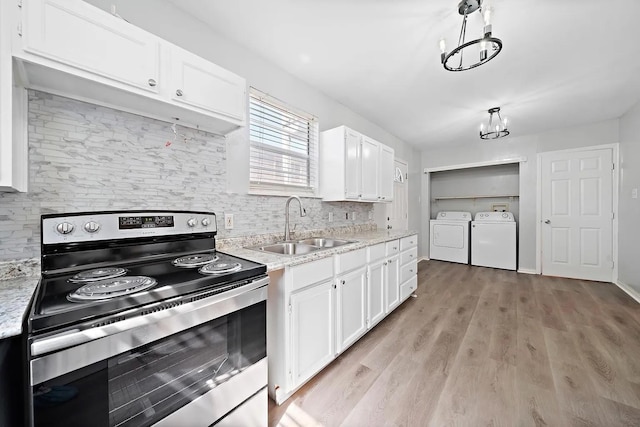 kitchen with stainless steel range with electric cooktop, independent washer and dryer, backsplash, a sink, and white cabinetry