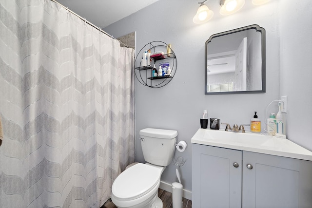full bathroom with wood finished floors, toilet, and vanity