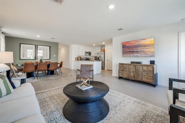 352 Amy St, Angleton, TX 77515 - living room featuring light wood finished floors, recessed lighting, and baseboards