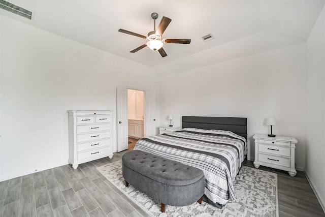 bedroom featuring lofted ceiling, wood finished floors, visible vents, and a ceiling fan