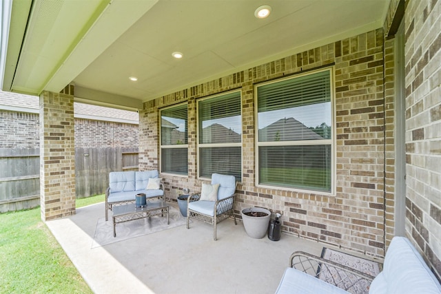 view of patio / terrace with an outdoor living space and fence