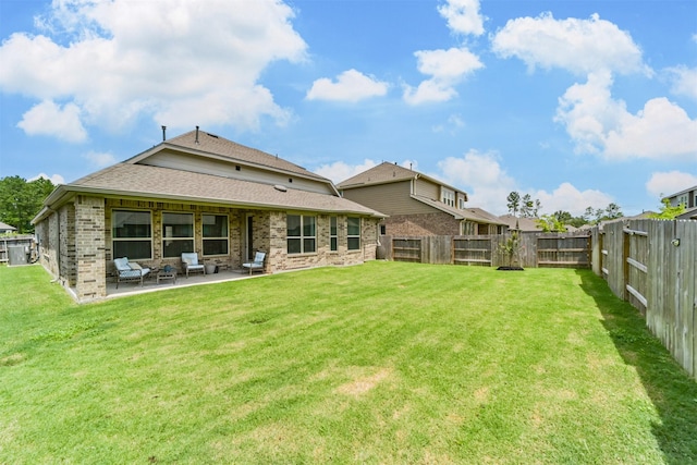 back of property featuring a patio, a fenced backyard, and a lawn
