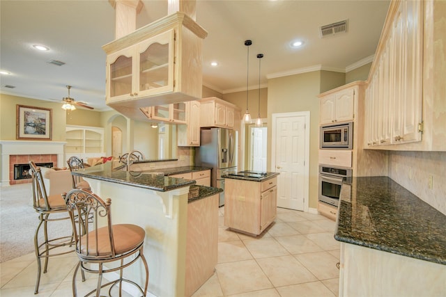 kitchen with ceiling fan, visible vents, stainless steel appliances, ornamental molding, and a peninsula