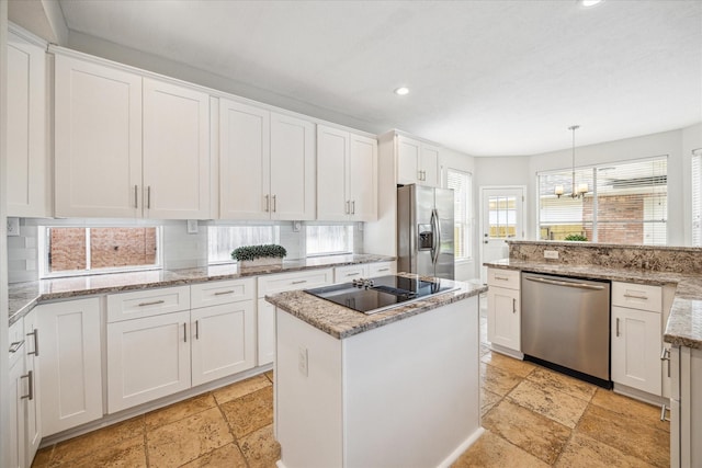 kitchen with recessed lighting, stone tile floors, appliances with stainless steel finishes, and white cabinets